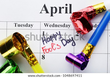 April calendar with inscription Happy Fools Day and blower