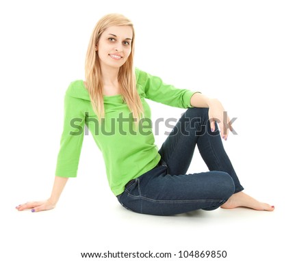 happy young woman sitting on the floor, full length, white background
