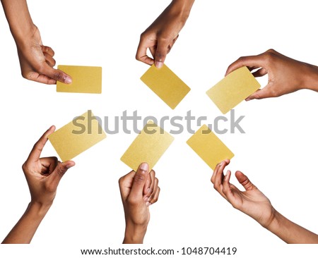 Set of african-american man's hands holding golden empty business or credit cards with copy space. Isolated at white background