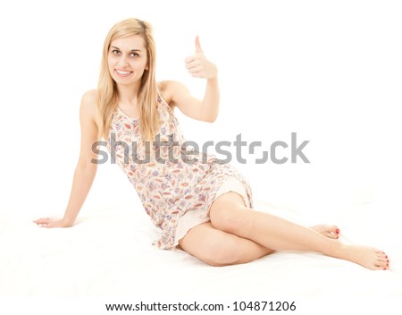 smiling young woman with thumb up, full length, white background