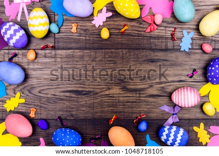 Happy Easter concept. Colorful easter eggs with silhouette of rabbit on wooden background Royalty-Free Stock Photo #1048718105