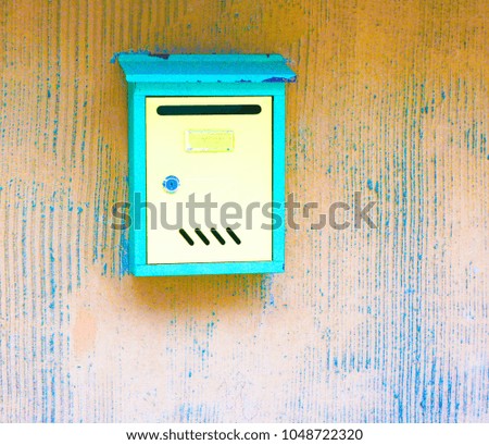Letter box at the wooden wall