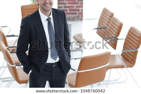 Business man standing in an empty meeting room