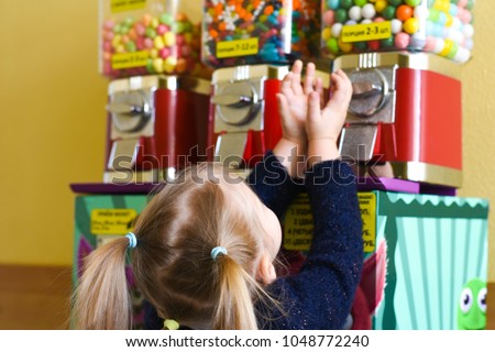 The girl asks the children's act of giving out sweets of chewing gum, marmalade, sweets Royalty-Free Stock Photo #1048772240