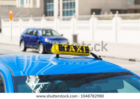 taxi sign on the roof of a taxi car