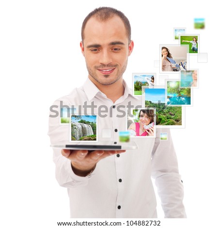Portrait of young happy man sharing his photo and video files in social media resources using his modern tablet computer. Isolated on white background