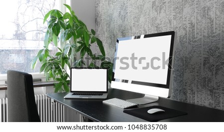 Workspace with computer and laptop at home or studio