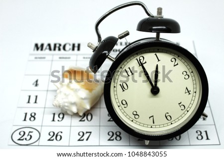 Daylight Savings Spring Forward sunday at 1:00 a.m. March 25 date indicated in the calendar. Clock next to a conch.