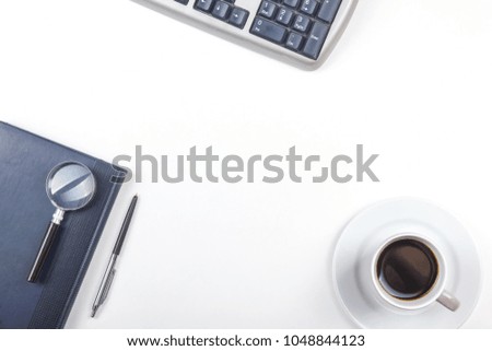 White Office desk table with computer, pen and a cup of coffee, lot of things. Top view with copy space