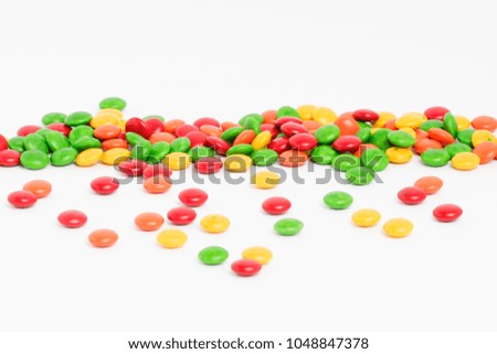Creative arrangement of colorful candies and sweets on white background
