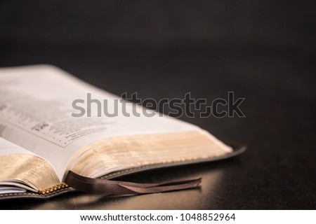 Open Bible on a Slate Tabletop with Customizable Space to Add Text Royalty-Free Stock Photo #1048852964