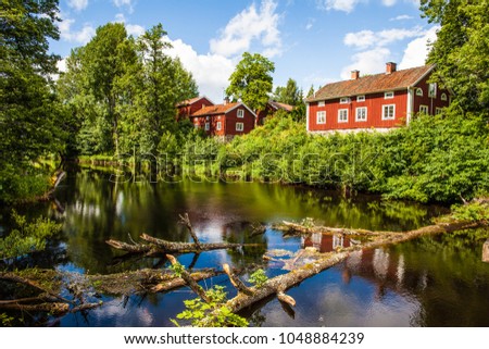 Red houses in Västmanland, Sweden Royalty-Free Stock Photo #1048884239