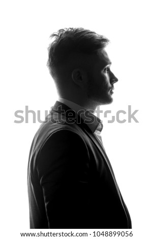 Young man silhouette in suit profile on a white isolated background.
