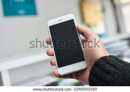 Businessman use mobile phone on light background for photo or video. Writing text, checking calls, reading messages. Close up picture of communication display technology device