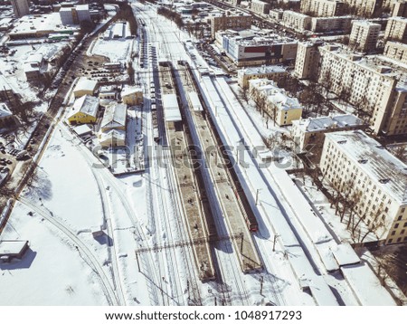aerial view of train on railway passing by in the city on a winter day
