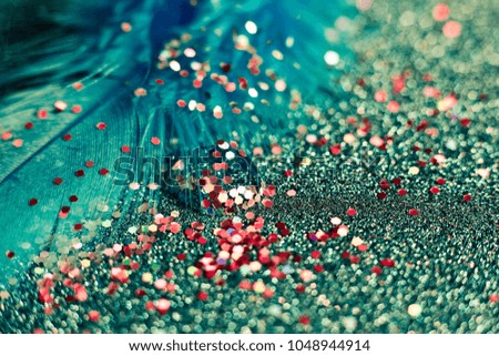 Soft feather with sparkles with artistic bright light and shadows. Soft blurred background of artistic close-up glitter macro image.