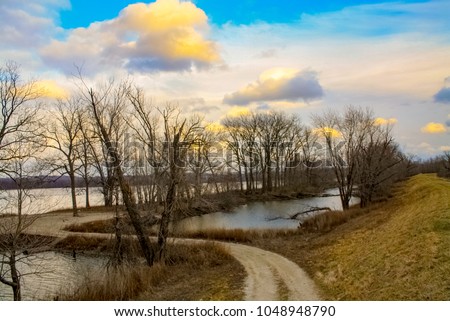 Colorful sunset photo of trees along the bank of the Missouri River at the Leach Memorial Conservation Area In Elsberry Missour
