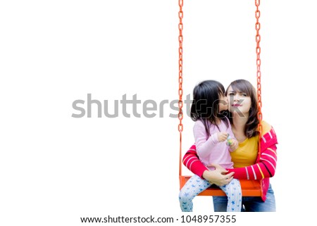 Picture of cute little girl kissing her mother while sitting on a swing, isolated on white background