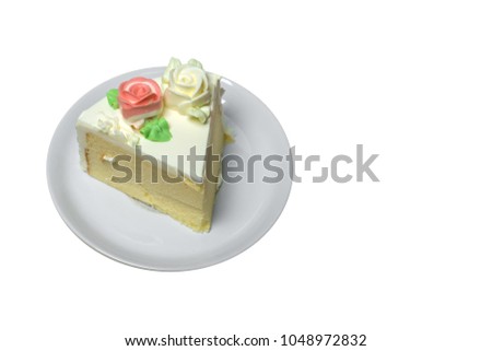 Fresh cake and cream flower in white ceramic dish with white background.