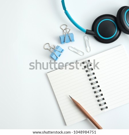 Styled stock photography white office desk table with blank notebook, keyboard, macaroon, supplies and coffee cup. Top view with copy space. Flat lay.
