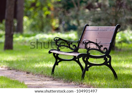 Stylish bench in summer park Royalty-Free Stock Photo #104901497