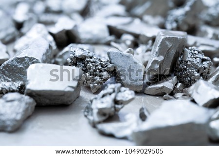 lump of silver or platinum on a stone floor Royalty-Free Stock Photo #1049029505