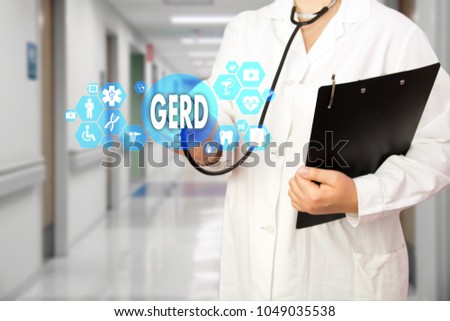 Medical Doctor with stethoscope and word GERD, Gastroesophageal reflux disease in Medical network connection on the virtual screen on hospital background.Technology and medicine concept.  Royalty-Free Stock Photo #1049035538