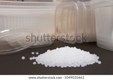 Transparent Polyethylene granules and plastic containers for the background. Plastic granules. Plastic Raw material in pellets.High Density Polyethylene (PE-HD).PE-LD. BPA FREE.  Royalty-Free Stock Photo #1049035661