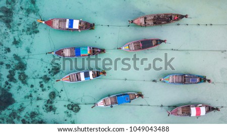 Aerial view of longtail boats moored by the beach in Koh Lipe, Thailand.  