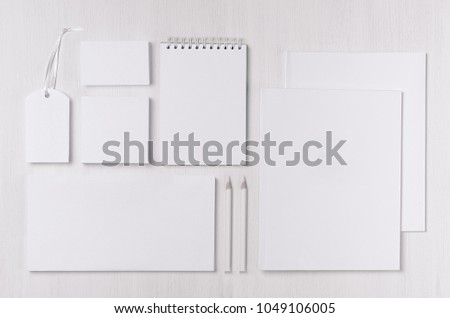 Corporate identity template with black white paper stationery set on soft white elegans wood board. Mock up for branding, business presentations and portfolios.