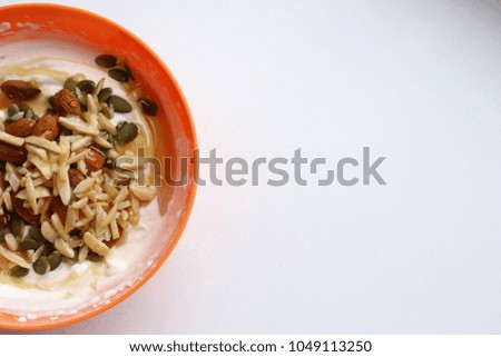 Healthy breakfast in orange bowl (half)