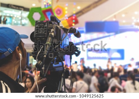 The camera man taking photos and recording video on stage.