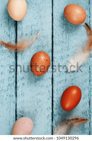 Beautiful raw chicken eggs on a blue wooden background