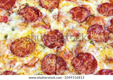 Pizza Pepperoni. Cheese and pieces of salami in close-up