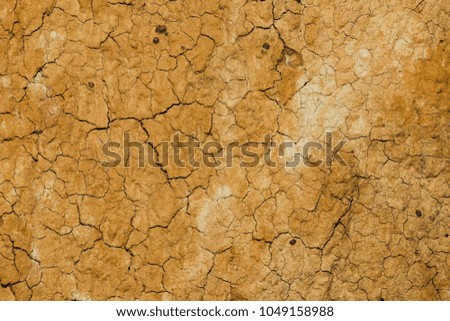 top view cracked  red soil ground Earth for texture background,desert cracks,Dry Orange surface Arid,drought land,Picture of natural disaster. drought land Caused by global warming and deforestation.
