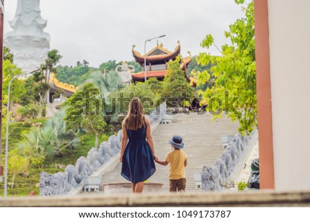 Happy tourists mom and son in Pagoda. Travel to Asia concept. Traveling with a baby concept
