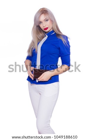 studio isolated portrait of a young blond woman in white trouser suit. The girl is holding a purse.