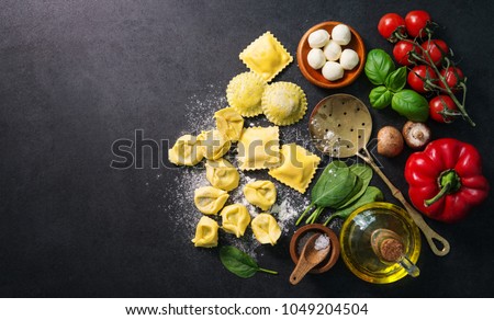 Homemade fresh Italian ravioli pasta on dark background, top view Royalty-Free Stock Photo #1049204504