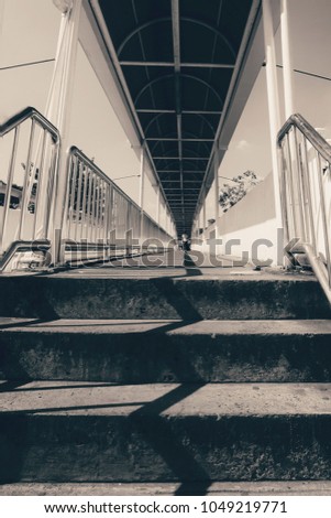 light and shadow on the concrete stairs to the overpass with vintage style, sepia style, vertical of art, street photo.