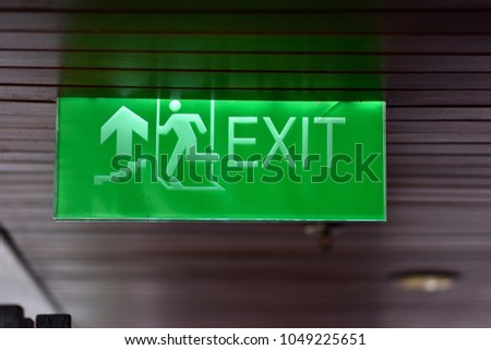 Exit sign hang on wooden ceiling