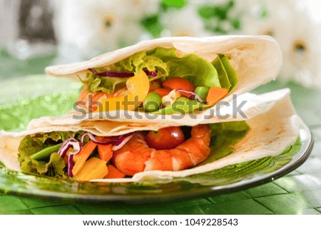 Shrimp with vegetables wrapped in a tortilla