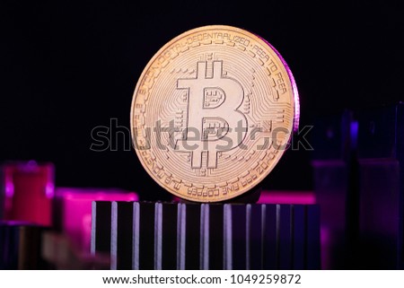 Photo of virtual currency, bitcoin and processor on pink background