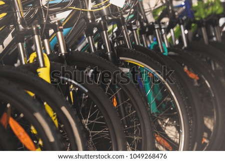 close-up view of wheels of bikes selling in bicycle shop