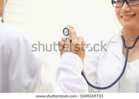 Female doctor holding stethoscope, Young female doctor working at the hospital office