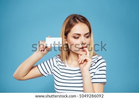 woman holding a business card thinks