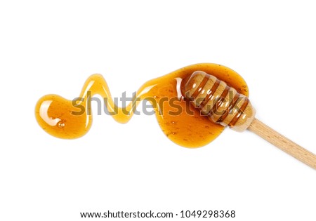 Honey and wooden dipper isolated on white background, top view Royalty-Free Stock Photo #1049298368