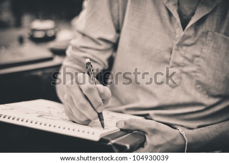 Male artist drawing Royalty-Free Stock Photo #104930039