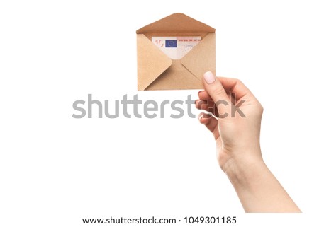 Woman hands holds an envelope with euro banknotes isolated on a white background. Home mortgage loan.