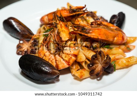 Seafood for frying on a metal background on a professional restaurant kitchen. Selective focus. Shallow depth of field.