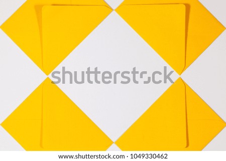 Pattern from yellow envelopes on the white table